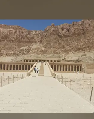 a bridge in the middle of a desert with mountains at House of peace in Al Aqālitah