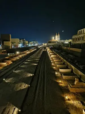 a row of train tracks at night at House of peace in Al Aqālitah