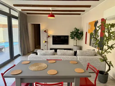 a living room with a table and a couch at Modern 2BR Villa With Private Pool In Bali In ElGouna in Hurghada