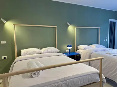 two beds in a room with green walls at Modern 2BR Villa With Private Pool In Bali In ElGouna in Hurghada