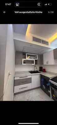 a white kitchen with a sink and a stove at Luxus Apartment in Hurghada