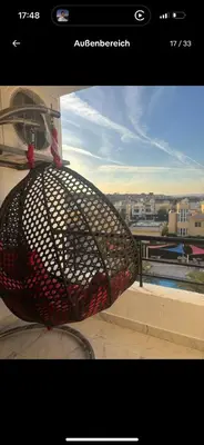 a net on a window with a view of a city at Luxus Apartment in Hurghada