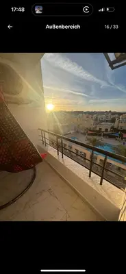 a view of the sunset from a balcony of a building at Luxus Apartment in Hurghada