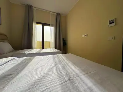 a bedroom with two beds and a window at Diamond Aldau in Hurghada