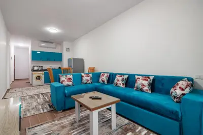 a blue couch in a living room with a table at Al Saraya Sahl Hasheesh by Peaks One Bedroom Apartment With Pool View C304 in Hurghada
