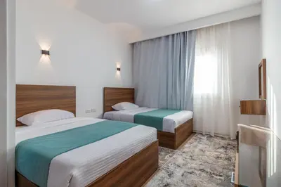 a hotel room with two beds and a window at Al Saraya Sahl Hasheesh by Peaks One Bedroom Apartment With Pool View C304 in Hurghada