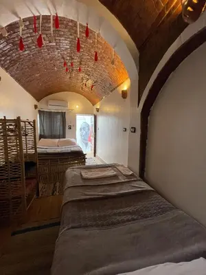 a bedroom with two beds in a room with a ceiling at Torya guesthouse in Aswan