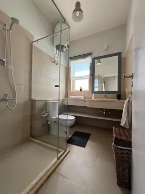 a bathroom with a shower and a toilet and a sink at El Gouna 2 BR Apartment in Hurghada