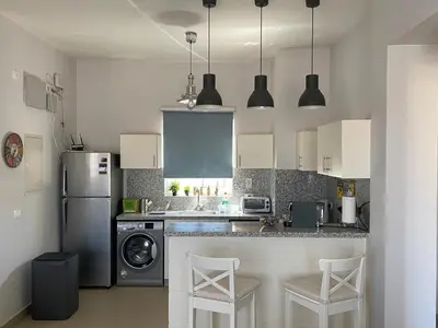 a kitchen with a refrigerator and a dishwasher at El Gouna 2 BR Apartment in Hurghada