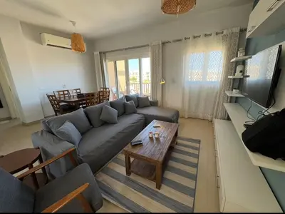 a living room with a couch and a table at El Gouna 2 BR Apartment in Hurghada