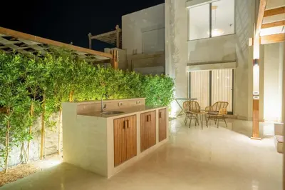 a kitchen with a sink and a table with chairs at Bright Shedwan 3BR • Modern Townhouse in Hurghada