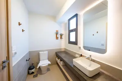 a bathroom with a sink and a toilet at Bright Shedwan 3BR • Modern Townhouse in Hurghada