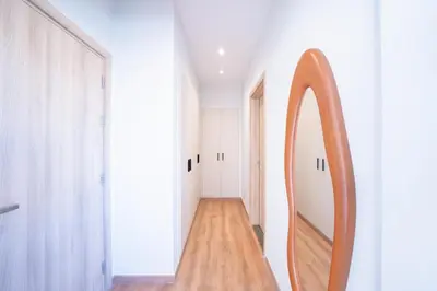 a hallway with a mirror and a wooden floor at Bright Shedwan 3BR • Modern Townhouse in Hurghada