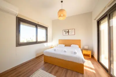 a bedroom with a large bed and a window at Bright Shedwan 3BR • Modern Townhouse in Hurghada