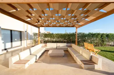 an outdoor seating area with a wooden ceiling at Bright Shedwan 3BR • Modern Townhouse in Hurghada