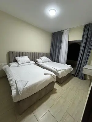 two beds in a hotel room with at 1-Bedroom Aldau Heights in Hurghada