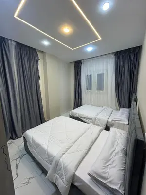 a bedroom with two twin beds in it at Two Bedroom Apartment in Hurghada