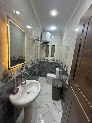 a bathroom with a sink and a toilet at Two Bedroom Apartment in Hurghada