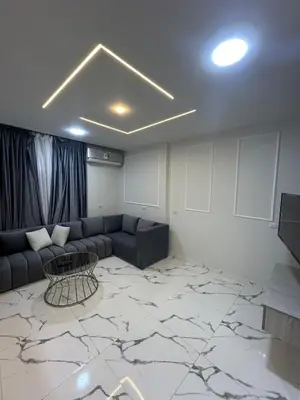 a living room with a couch and a table at Two Bedroom Apartment in Hurghada