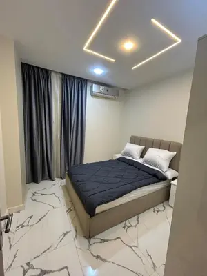 a bedroom with a bed in a room with marble floors at Two Bedroom Apartment in Hurghada
