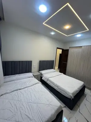 two beds are in a room with at Two Bedroom Apartment in Hurghada