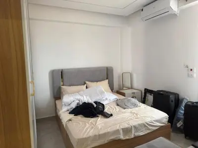 a bedroom with a bed with a backpack on it at Modern 2 Bedroom Apartment with Private Beach Hurghada in Hurghada