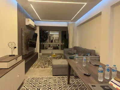 a living room with a couch and a table with water bottles at Modern 2 Bedroom Apartment with Private Beach Hurghada in Hurghada
