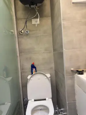 a small bathroom with a white toilet in a room at Modern 2 Bedroom Apartment with Private Beach Hurghada in Hurghada