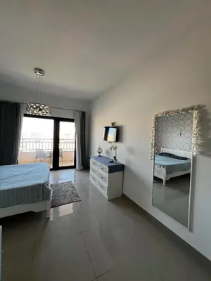 a bedroom with a bed and a mirror on the wall at Luxury Studio in Aldau Heights Hurghada in Hurghada