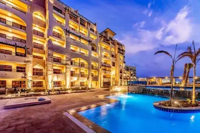 a hotel with a swimming pool in front of a building at Luxury Studio in Aldau Heights Hurghada in Hurghada