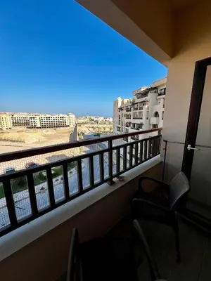a room with a balcony with a view of the water at Luxury Studio in Aldau Heights Hurghada in Hurghada