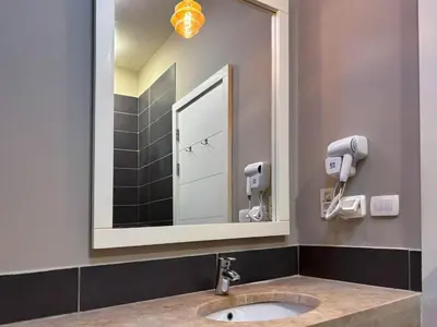 a bathroom with a sink and a mirror at Vibrant 3BR Villa - Free Pool & Lagoon Access At ElGouna in Hurghada
