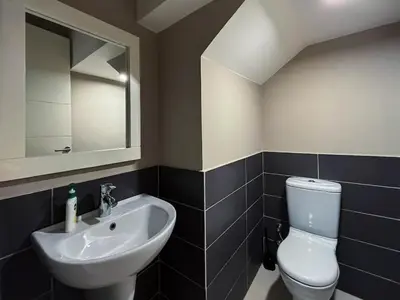 a bathroom with a white toilet and a sink at Vibrant 3BR Villa - Free Pool & Lagoon Access At ElGouna in Hurghada