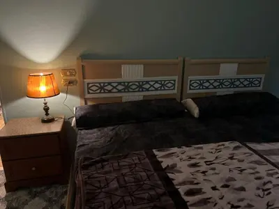a bedroom with two twin beds and a lamp at Centre point Aswan in Aswan