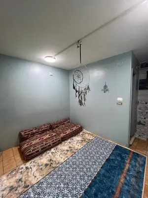 a room with a wall with a clock and a rug at Centre point Aswan in Aswan