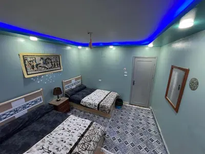 a room with two beds and a blue ceiling at Centre point Aswan in Aswan