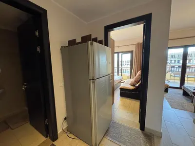 a kitchen with a stainless steel refrigerator in a room at Sun & Fun Aldau Heights one bedroom apartment in hurghada in Hurghada