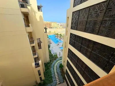 a view from the balcony of a building with a pool at Aldau Heights one bedroom apartment in Hurghada cr in Hurghada