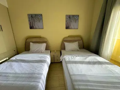 two beds sitting next to each other in a room at Aldau Heights one bedroom apartment in Hurghada cr in Hurghada