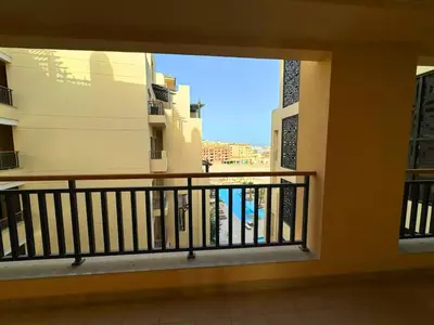 a balcony of a building with a view of the ocean at Aldau Heights one bedroom apartment in Hurghada cr in Hurghada