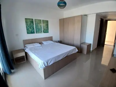 a bedroom with a large bed with white sheets at Gcribs B7F7 in El Gouna