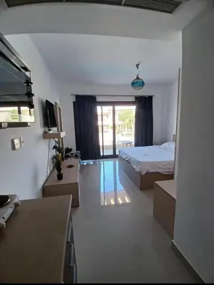 a bedroom with a bed and a television in a room at Gcribs B7F7 in El Gouna