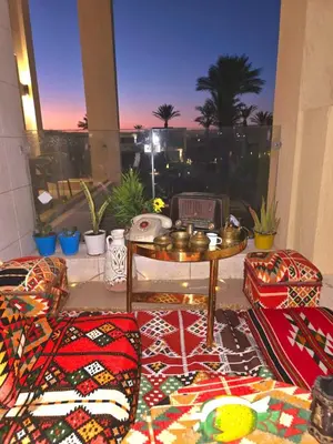 a room with a table and chairs and a window at Gcribs B7F7 in El Gouna