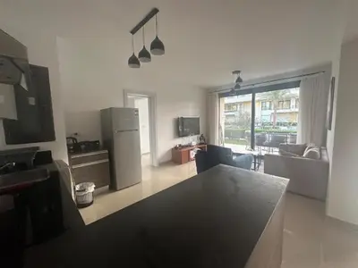 a kitchen and living room with a refrigerator and a couch at Hotel apartment in G cribs 2BR in El Gouna