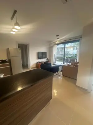 a large living room with a kitchen and a living room at Hotel apartment in G cribs 2BR in El Gouna