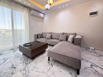 a living room with a couch and a table at 2 bedrooms in Hurghada Hub Resort in Hurghada