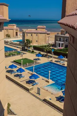 an overhead view of a pool with chairs and umbrellas at Selena Bay Resort in Hurghada
