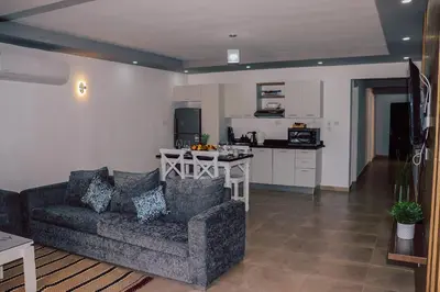 a living room with a couch and a kitchen at Selena Bay Resort in Hurghada