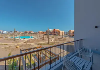 a balcony with a view of a playground at Brand-New 1BR in Kamaran El Gouna I Pool View & Access in Hurghada