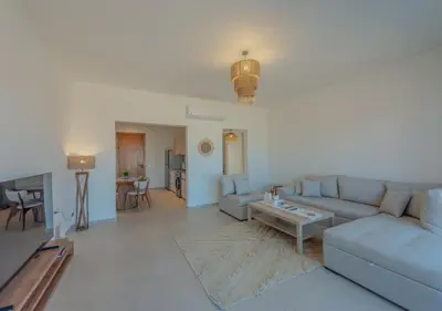 a living room with a couch and a table at Brand-New 1BR in Kamaran El Gouna I Pool View & Access in Hurghada